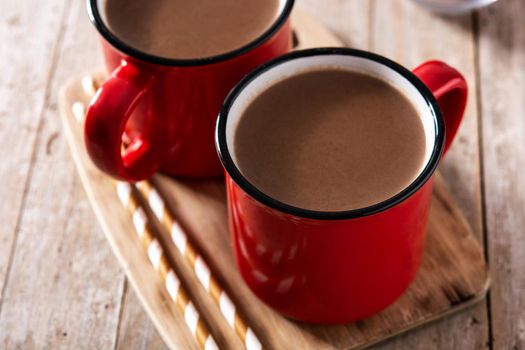 Traditional Mexican chocolate atole drink on wooden table