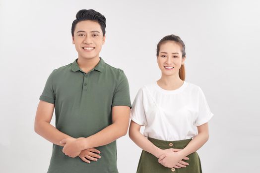 Photo of happy boyfriend and girlfriend smiling and looking on each other isolated over white background