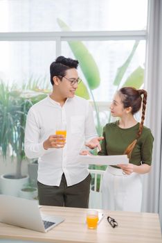 two young colleagues working in an office.