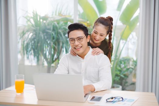 Happy family couple spending time together at home. Bright spacious apartment