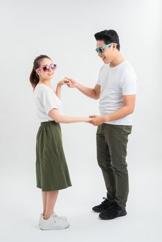 Attractive couple dancing isolated over white background