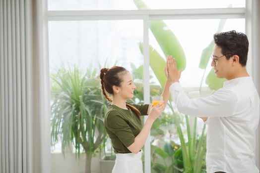 situation in office - two workers giving high five