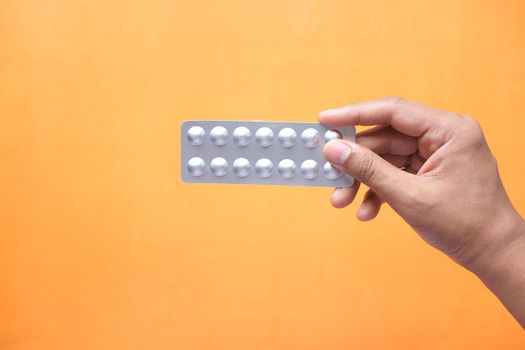 Close up of man holding blister packs