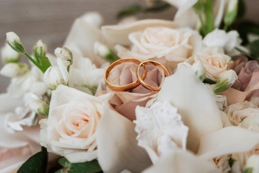 gold wedding rings as an attribute of a young couple's wedding