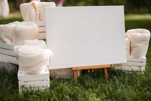 white plush blankets in wooden boxes for event invitees