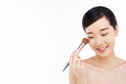 Beauty Concept - Beauty asian woman applying make up with brush of cheek isolated on white background, beautiful of girl holding blusher