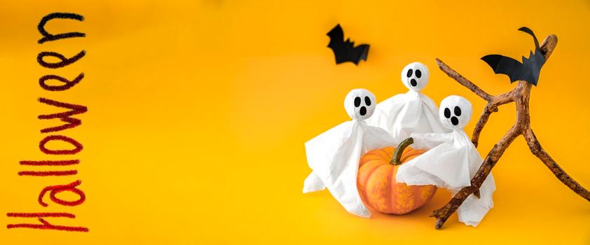 Pumpkin, gosts and bats on orange background, symbols Halloween. Banner, copy space