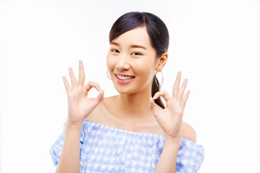 young Asian woman showing okay finger sign isolate over white background