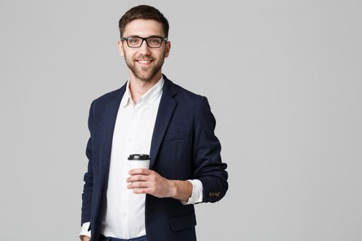 Portrait of a handsome businessman in eyeglasses with a cup of coffee.