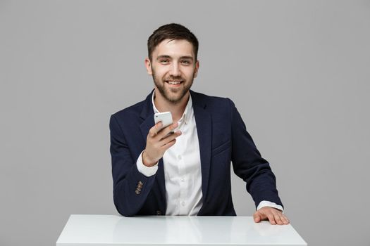 Business Concept - Portrait Handsome Business man playing phone with smiling confident face. White Background.Copy Space.