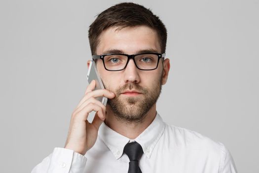 Lifestyle and Business Concept - Portrait of a handsome businessman serious talking with mobile phone. Isolated White background. Copy Space.