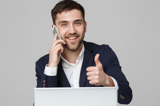 Business Concept - Portrait Handsome Business man showing thump up and smiling confident face in front of his laptop. White Background.Copy Space.