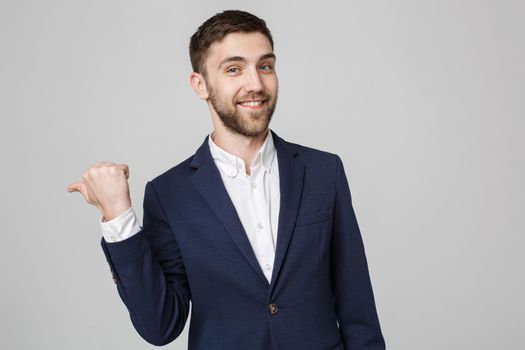 Business Concept - portrait young successful businessman posing over dark background. Copy space.