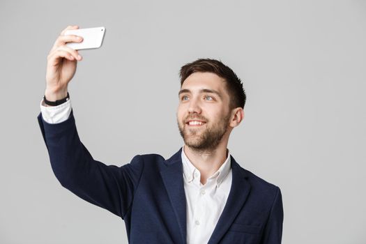 Business Concept - Handsome Business man take a selfie of himself with smartphone. White Background.