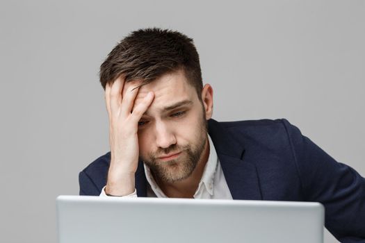 Business Concept - Portrait handsome stressful business man in suit shock looking at work in laptop. White Background.