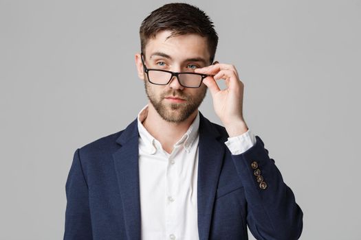 Business Concept - Portrait of a handsome businessman in suit with glasses serious thinking with stressful facial expression. Isolated White background. Copy Space.