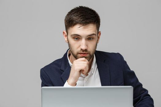 Business Concept - Portrait handsome stressful business man in suit shock looking in front of laptop at work office. White Background