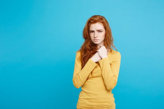 Healthcare Concept - Portrait of young beautiful ginger woman feeling sick and stressful. Isolated on pastel blue background. Copy space.