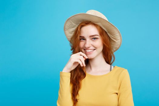 Travel concept - Close up Portrait young beautiful attractive redhair girl with trendy hat and smiling. Blue Pastel Background. Copy space.