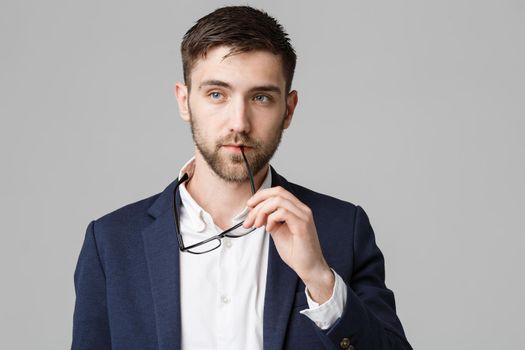 Business Concept - Portrait of a handsome businessman in suit with glasses serious thinking with stressful facial expression. Isolated White background. Copy Space.