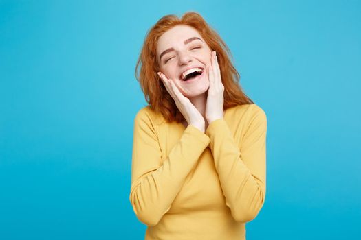 Lifestyle concept - Portrait of cheerful happy ginger red hair girl with joyful and exciting smiling to camera. Isolated on Blue Pastel Background. Copy space.