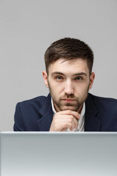 Business Concept - Portrait handsome stressful business man in suit shock looking at work in laptop. White Background.