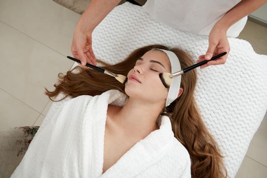 Face Skin Care. Woman Gets Brushes Treatment At Beauty Clinic