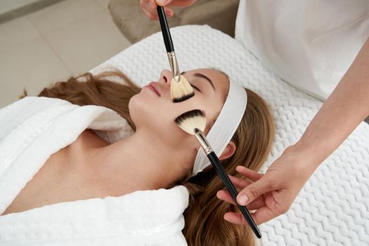 Face Skin Care. Woman Gets Brushes Treatment At Beauty Clinic