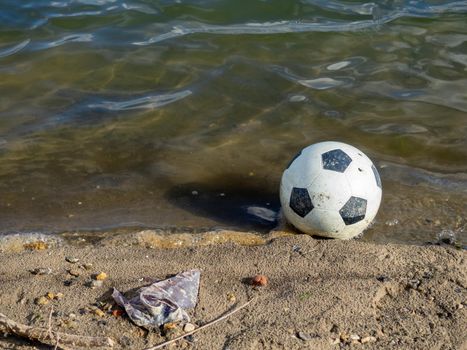 Soccer ball in the water. The ball fell into the river
