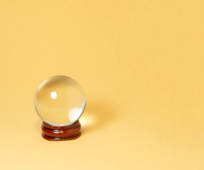 Crystal ball on a yellow background.
