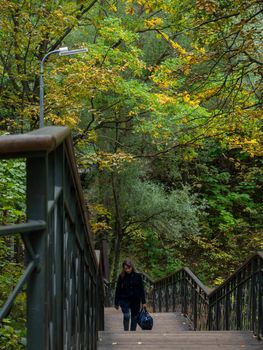 Kazan. Russia. 09-19-2021 Walk across the bridge over the stream in the forest