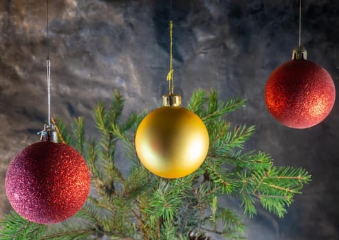 golden and red Christmas balls on the background of fir branches. Christmas decoration
