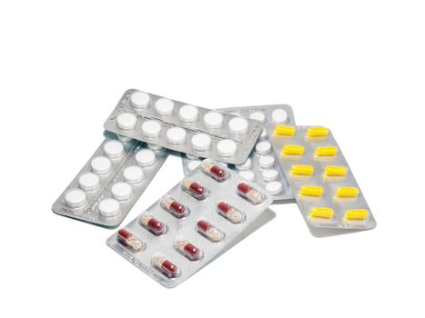 Pills on a white background. Various medicines in blisters.
