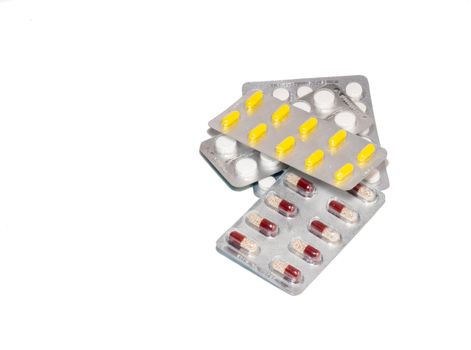 Pills on a white background. Various medicines in blisters.