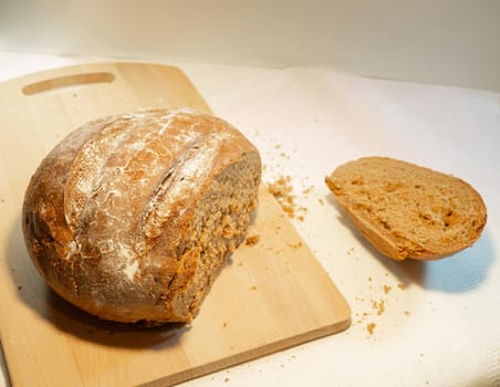 Cut rye bread lies on the board. Fresh bakery

