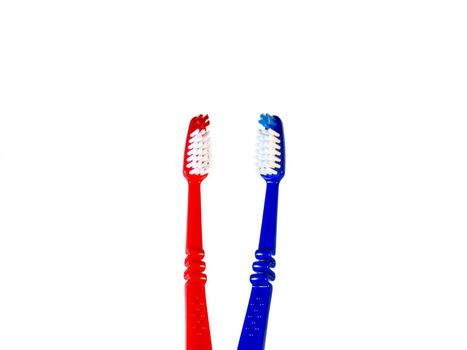 Two toothbrushes on a white background. Blue and red toothbrushes
