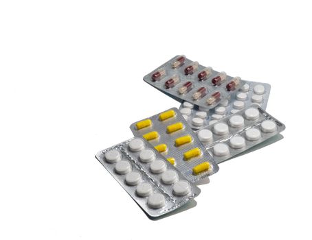 Pills on a white background. Various medicines in packages.
