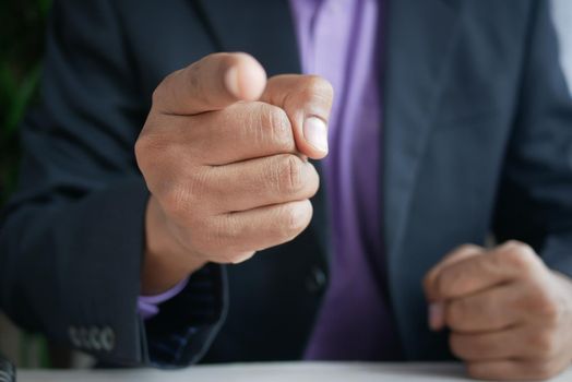 Businessman in suit point finger at camera