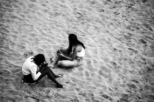 People sunbathing by the shore on the beach on a Sunny day of Autumn in Benidorm