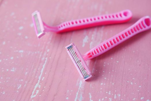close up of pink color razor on table