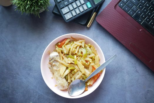 fresh vegetable salad in bowl on office desk ,