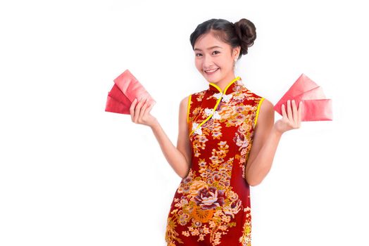 Young Asian beauty woman wearing cheongsam and carry red packet of money in Chinese new year festival event on isolated white background. Holiday and Lifestyle concept. Qipao dress wearing