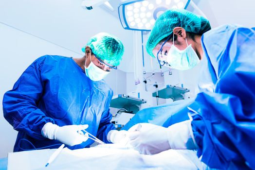 Doctor and assistant nurse operating for help patient from dangerous emergency case, Hospital and Surgery Concept, Health care and Medical concept, Cancer and disease treatment