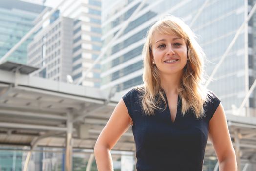 Beauty woman portrait with city and building background. Happy life of people concept. Smiling lady theme.