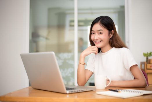 Businesswoman working at home with laptop for surfing the internet for commercial. Online shopping business and Relax on holiday concept