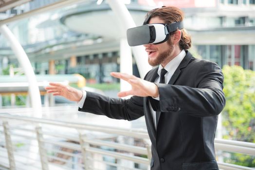 Businessman wearing virtual reality goggle glasses and enjoying in this activity, future technology concept, imagine concept