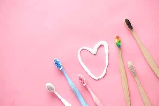 tooth brush and paste on pink ,