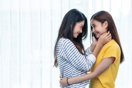 Two Asian women looking at each others in home. People and lifestyles concept.  LGBT pride and lesbian theme.