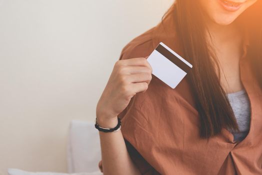 Young happy woman using credit card. Business and Online shopping concept. Financial and Moneys theme.