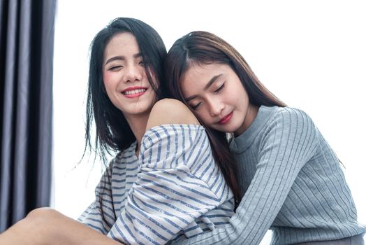 Two Asian Lesbian women hug and embracing together in bedroom. Couple people and Beauty concept. Happy lifestyles and home sweet home theme. Homosexual life theme. Love scene making of female